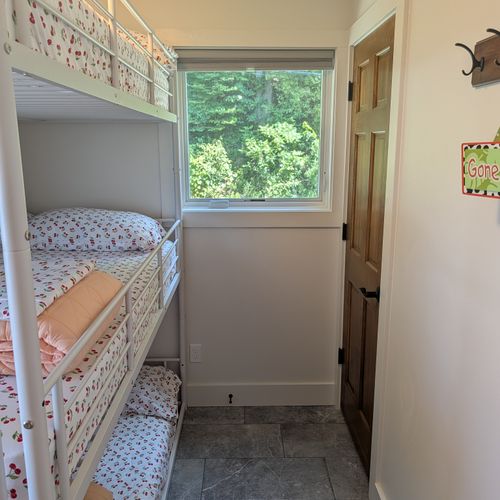 BEDROOM #2 (SECOND FLOOR):  Features a three-level bunk bed wtih a full-size mattress on each level.  Also has a closet, dresser, mirror, and lamp.