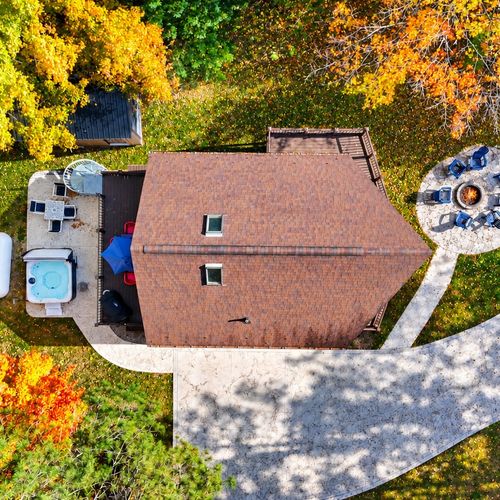 OVERVIEW:  Anoother aerial view of the property showing the 2 decks, bonfire ring, backyard, and the hot tub.