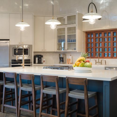 full-service kitchen - farmhouse sink, pro range, spiral staircase - built for hosted private-chef service.