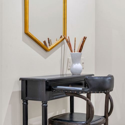 Gold hexagon mirror over a sleek vanity desk