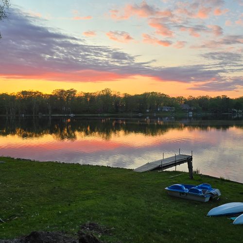 EXTERIOR:  Sunset view of Bass Lake with the private kayaks and the pedal boat shown in the photo.