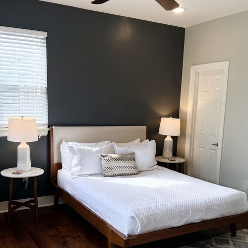 Cozy bedroom w/ bed & warm hardwood floors