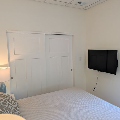 LIVING SPACE: The comfy full-size bed with a closet and smart TV. Perfect for relaxation!