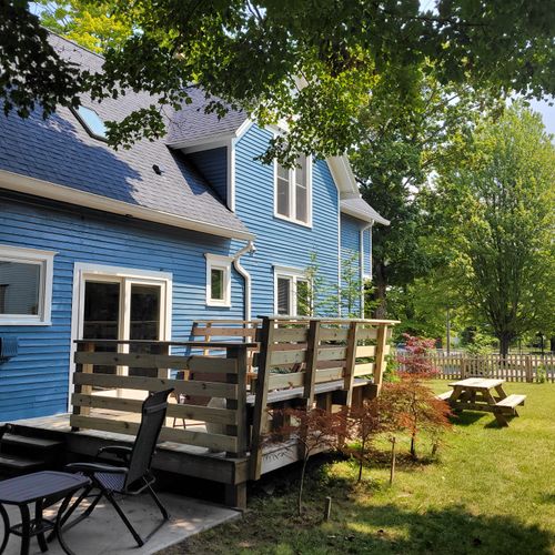 EXTERIOR: The large backyard and deck of the main house