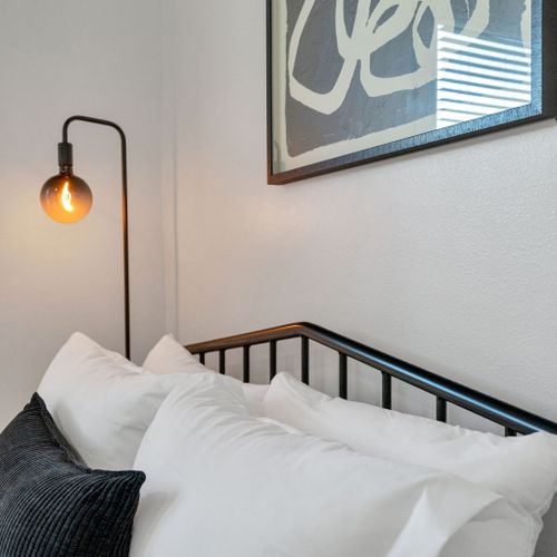 Sink into plush pillows & read by the warm glow of the wall lamp before bed