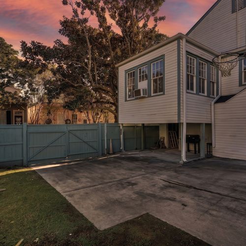 Exterior view of the property — a classic structure w/ gated access & ample space.