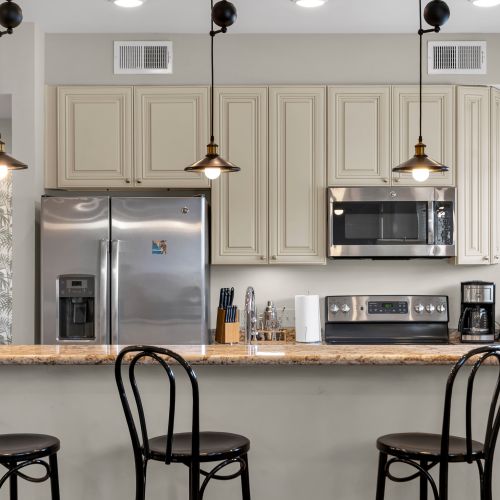 Kitchen bar with bistro chairs and stainless appliances