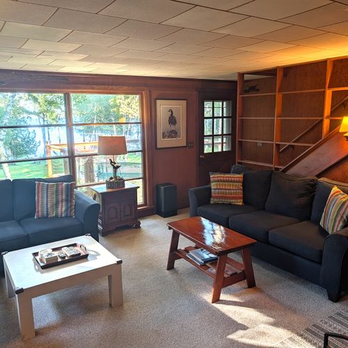 MAIN LIVING ROOM (FIRST FLOOR):  The home has a large, cozy, and comfortable living room on the main floor.  Note that the wood fireplace is available for guest usage.