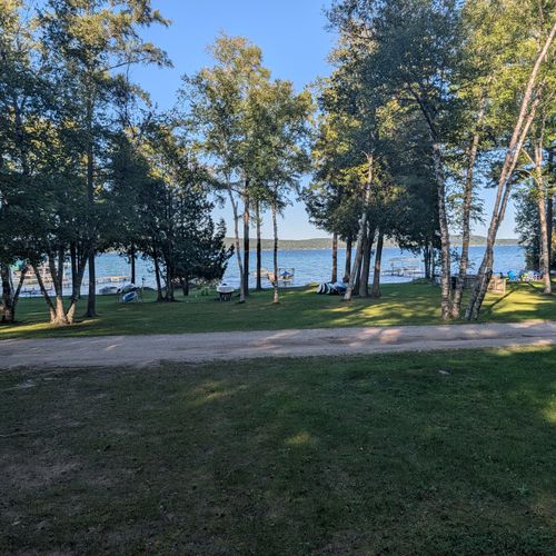 EXTERIOR:  Looking out over the large backyard.  Note that the road goes through the backyard between the house and the lake.
