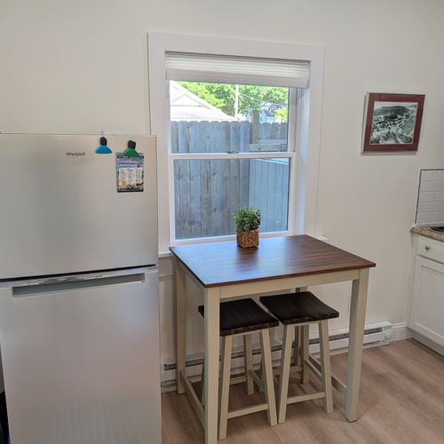 KITCHEN: The apartment's cute kitchen with a stove, microwave, coffeemaker, refridgerator, and other kitchen essentials. Perfect for cooking! The cute dining table offers a place to eat
