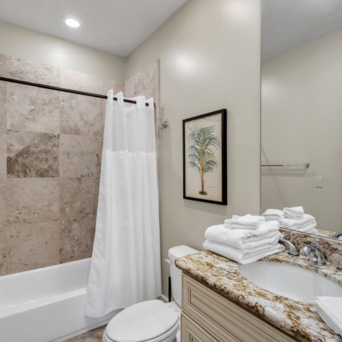 Bright full bath with tub and fresh towels