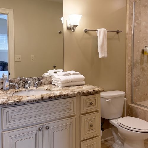 Elegant bathroom w/ double vanity & stone finish