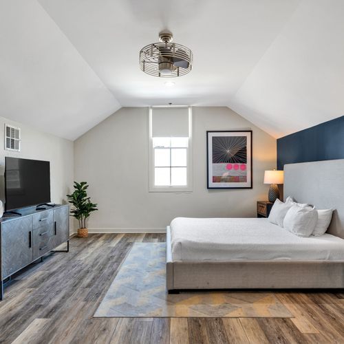 Vaulted ceiling bedroom with a Smart TV