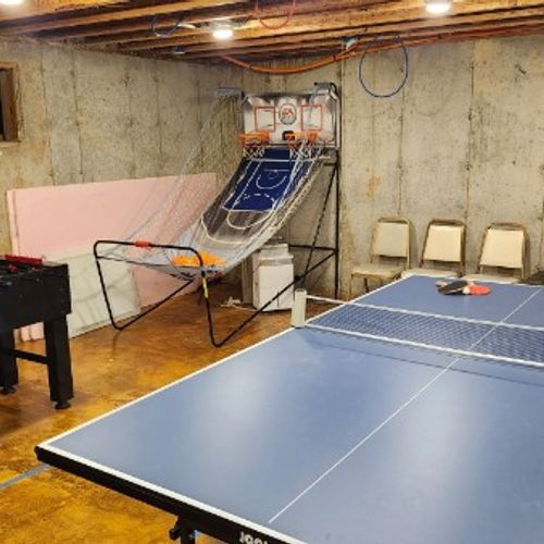 BASEMENT GAME ROOM:  Each reservation includes free use of the game room that is in the basement of the "big house" on the property (where the owners live).