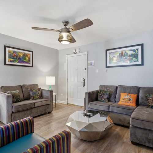 Bright living area w/ cozy seating & a welcoming, airy feel.