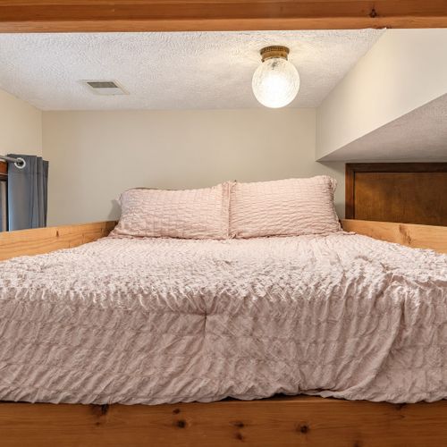 BEDROOM #2 (FIRST FLOOR):  Features a twin-on-twin bunk bed, nightstand, closet, dresser, and mirror.