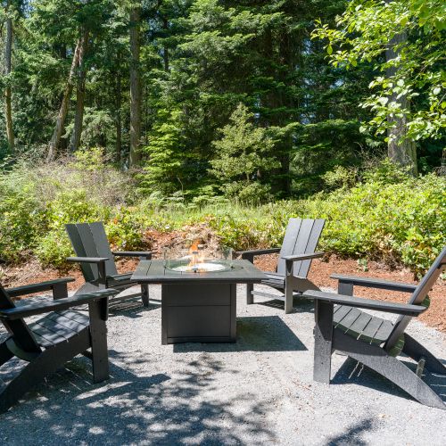 Gather around the fire pit with Adirondack seating, surrounded by peaceful forest views and fresh island air.