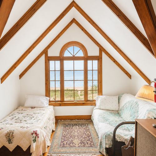 BEDROOM #5 (THIRD FLOOR):  This is a large and fun loft bedroom on the top floor.  Features 2 queen beds, a single bed, and a futon.  Also has its own bathroom.  Note that there are no window treatments though.