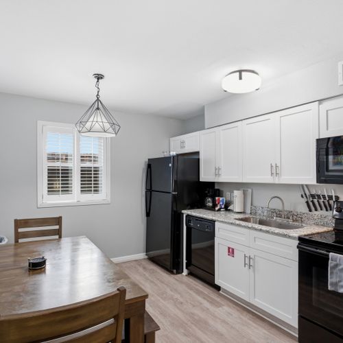 Unit 205 kitchen w/ clean white finishes, ready for home cooking.