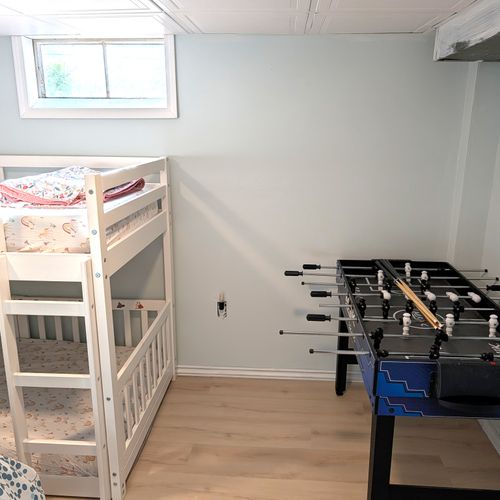 BEDROOM #3 (LOWER LEVEL):  Features a full-size bed, bunk bed, and a foosball table.