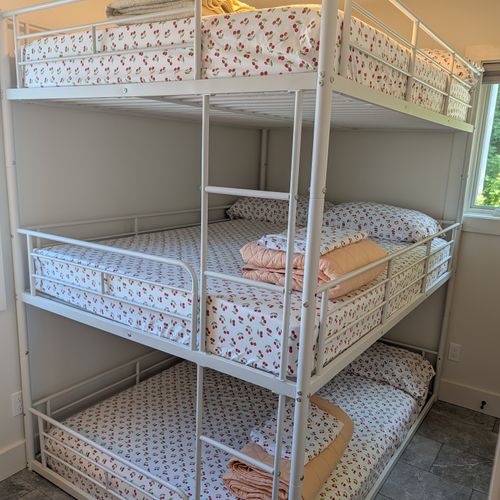 BEDROOM #2 (SECOND FLOOR):  Features a three-level bunk bed wtih a full-size mattress on each level.  Also has a closet, dresser, mirror, and lamp.