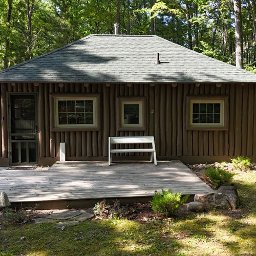 EXTERIOR:  The front of the cabin in the summer along with the front deck
