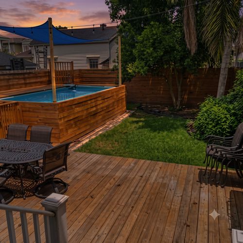 Lush backyard w/ pool, wood deck & grill — made for outdoor entertaining.