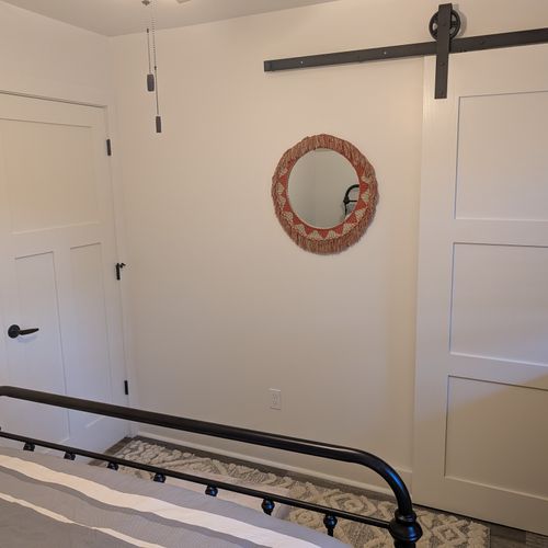 BEDROOM #2 (SECOND FLOOR):  Features a queen-size bed, nightstand, lamp, dresser, mirror, closet, and ceiling fan.