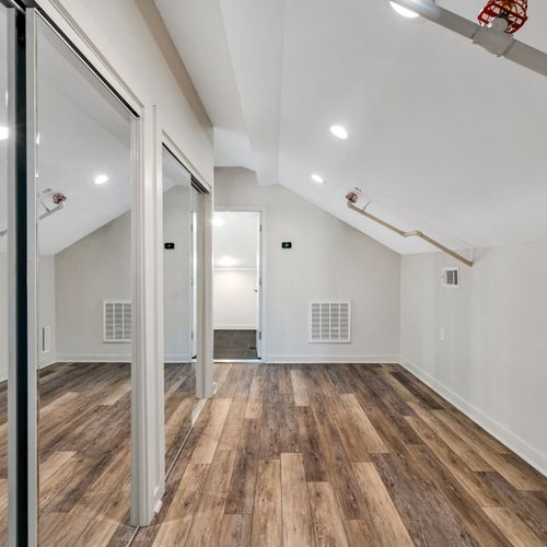 Vaulted loft space with mirrored closets