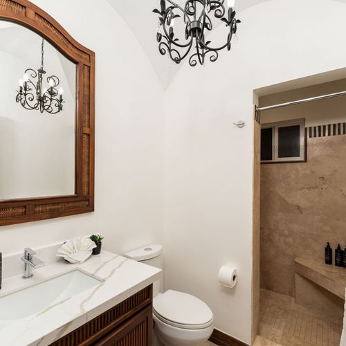 Guest bathroom with walk-in shower at back and spacious layout at luxury Playa Langosta condo in Tamarindo, Costa Rica. Clean design, modern fixtures, natural light, perfect for guests needing comfort and privacy during their stay.