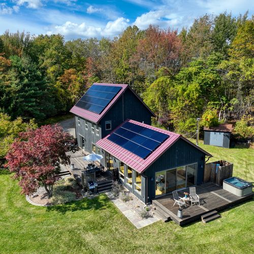 An aerial view of the main house, facing the hot tub deck and outdoor shower, just steps from the living room.