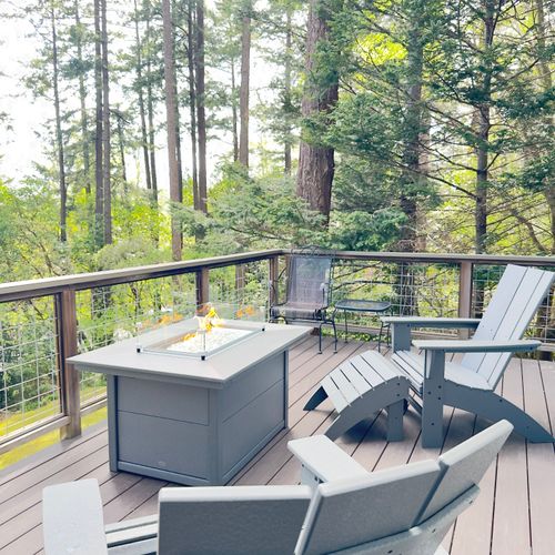 Comfortable Adirondack chairs and ottoman allow for early morning and evening relaxation.