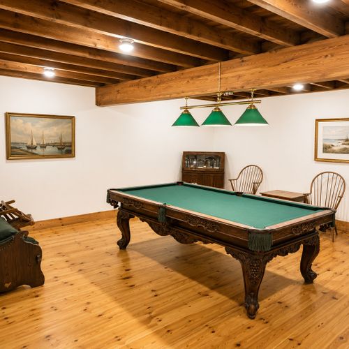 BASEMENT:  The home has a partially finished basement with a pool table, card table, bar, bedroom, and a full bathroom.