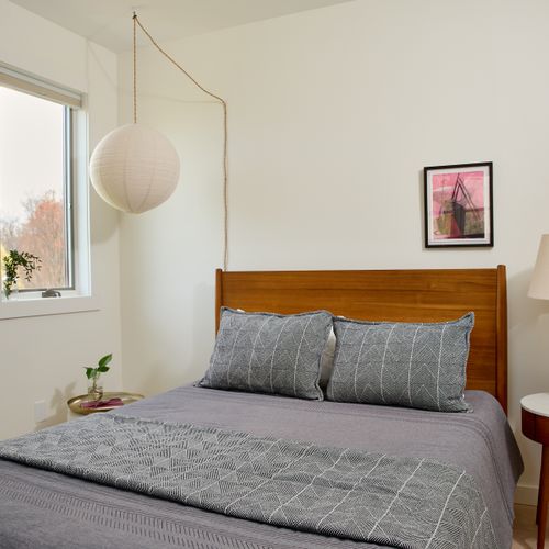 The first bedroom in the guest house, featuring a queen size bed.