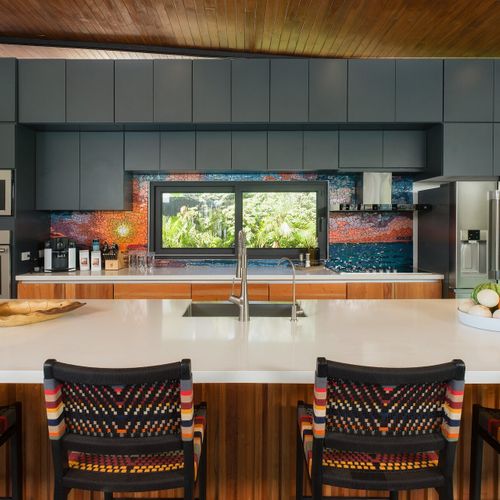 Gourmet chef kitchen with quartz island, stainless appliances and a Costa Rican mosaic backsplash at Casa Oso luxury villa, Tamarindo.