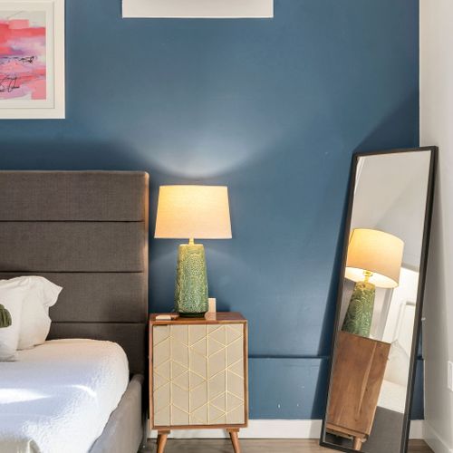 Rattan nightstand and lamp against deep blue