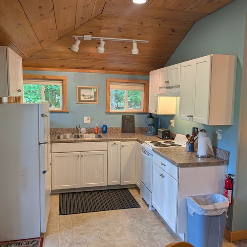 KITCHEN: The accommodating kitchen suited with a fridge, an oven, a toaster, a coffeemaker, and other kitchen essentials