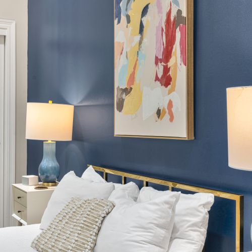 Splash of abstract color above the bed