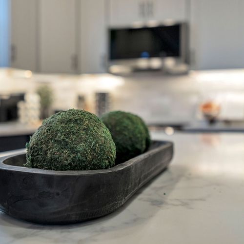 Mossy accents on the kitchen island add a fresh, natural touch