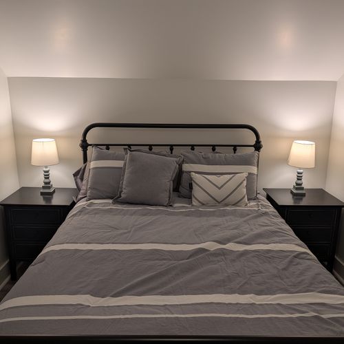 BEDROOM #1 (SECOND FLOOR):  Features a queen-size bed, nightstands, lamps, dresser, mirror, closet, and ceiling fan.