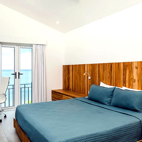 Upper-floor primary bedroom with king bed and ocean views at Mar Azul, Tamarindo, Costa Rica.