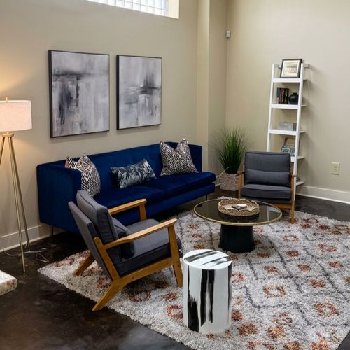 Bright open living space w/ blue sofa & cozy seating area