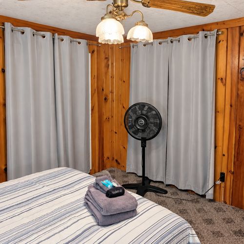 BEDROOM #1:   Features a queen-size bed, nightstands, lamp, dresser, closet, and chair.