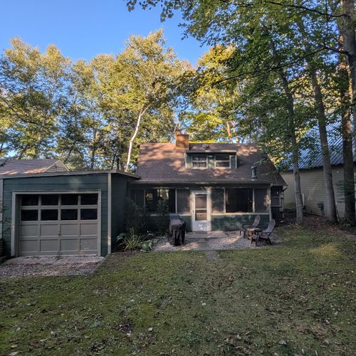 EXTERIOR:  The front of the house, with the gas grill visible.  (The garage is locked off for owner usage and is not available for guests.)