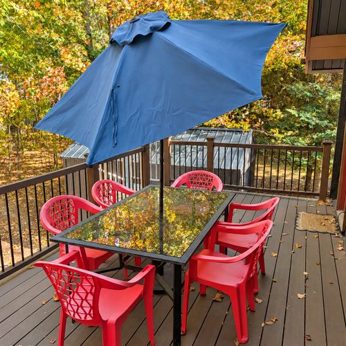 EXTERIOR:  The backyard deck, highlighting the outdoor dining furniture.