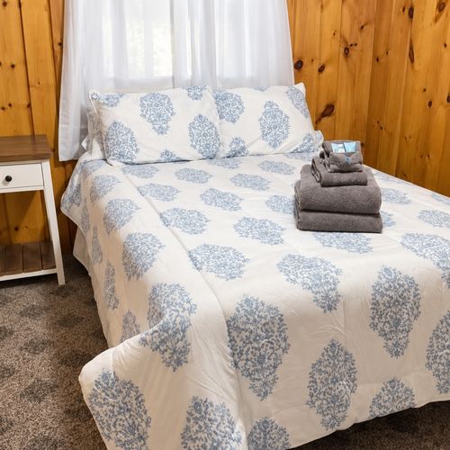 BEDROOM #3:   Features a full-size bed, nightstand, and a dresser.