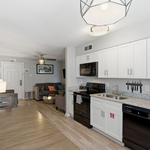 Fully equipped kitchen w/ modern appliances & dining space for meals at home.