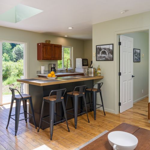 Bright open-concept kitchen with island seating and easy access to the outdoor patio