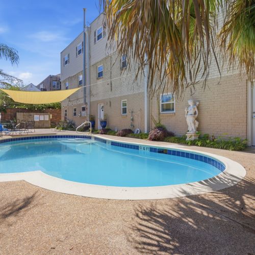 Sun-drenched pool tucked in a charming courtyard — perfect for cooling off.