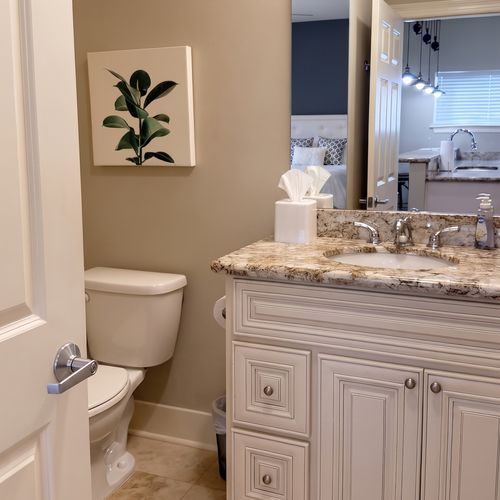 Bathroom w/ granite counters, double sinks & ample storage